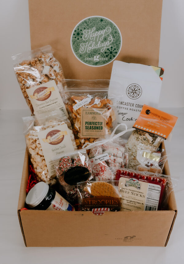 Gift box with locally made products including: coffee, peppermint bark, beef sticks, snickerdoodle popcorn, peppermint stroopie, jam, caramels, soup, seasoned pretzels, cinnamon bun popcorn, and non pareils.