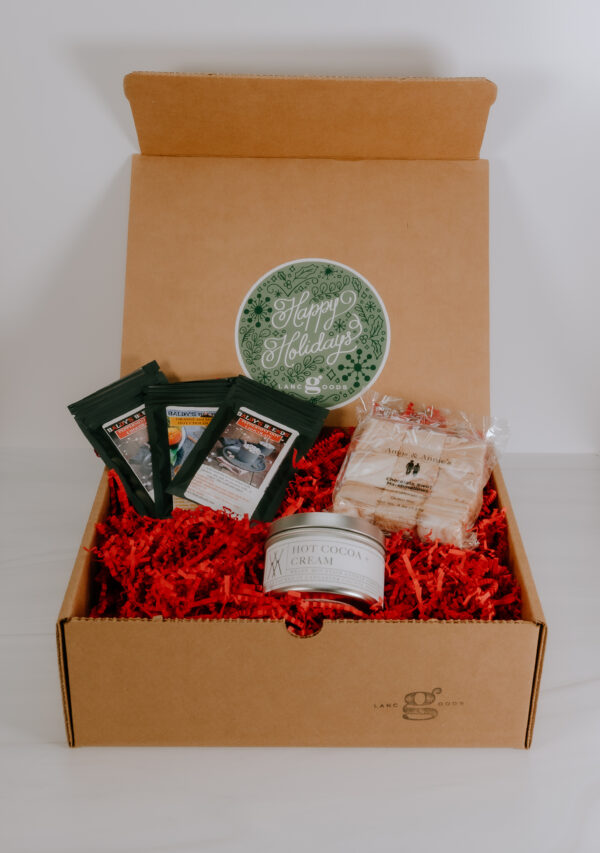 Gift box with locally made marshmallows, hot chocolate packets, and a hot chocolate flavored candle.