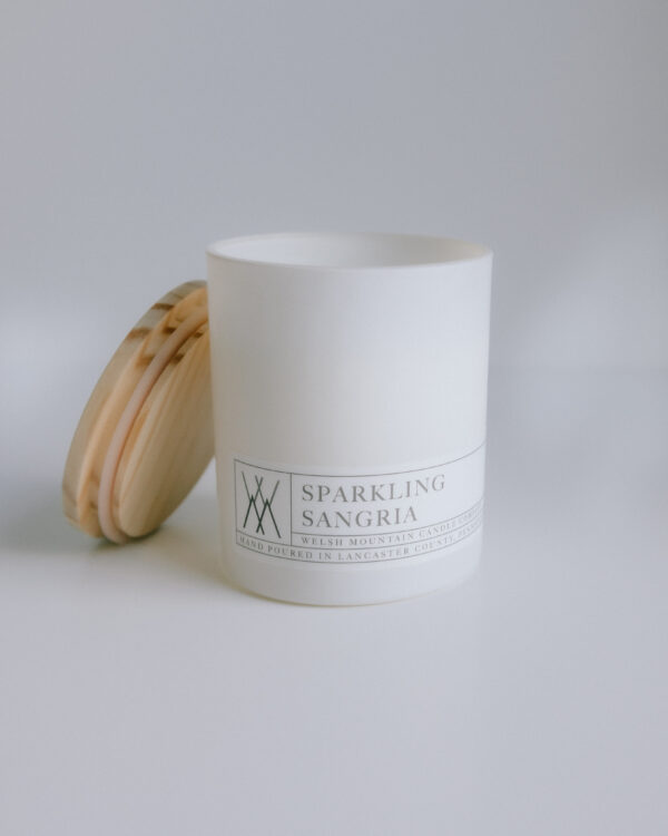 candle in white glass jar with bamboo lid