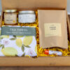 Lemon Edition Gift Box with artisan ginger lemon tea, lemon tea towel, lemon poppyseed candle, creamed honey, and natural chapstick from Lancaster County small businesses