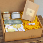 Lemon Edition Gift Box with artisan ginger lemon tea, lemon tea towel, lemon poppyseed candle, creamed honey, and natural chapstick from Lancaster County small businesses