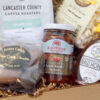 Deluxe Taste of Lancaster Edition Gift Box with coffee, potato chips, honey, jam, popcorn, pretzels, apple butter, stroopie, chocolate, and more. A generous Lancaster County gift, perfect for holidays, family gatherings, or corporate gifting.