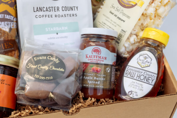 Deluxe Taste of Lancaster Edition Gift Box with coffee, potato chips, honey, jam, popcorn, pretzels, apple butter, stroopie, chocolate, and more. A generous Lancaster County gift, perfect for holidays, family gatherings, or corporate gifting.