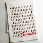 Fa La La Lancaster cotton dish towel in black and red text made by Building Character in Lancaster PA.