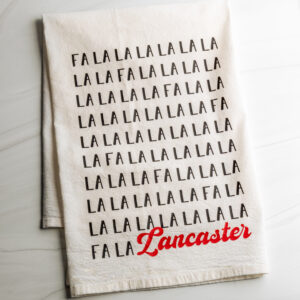 Fa La La Lancaster cotton dish towel in black and red text made by Building Character in Lancaster PA.