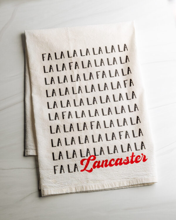 Fa La La Lancaster cotton dish towel in black and red text made by Building Character in Lancaster PA.