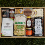 Deluxe Taste of Lancaster Gift Box featuring local Lancaster County products including coffee, pretzels, honey, popcorn, and apple butter.