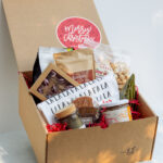 Deluxe Holiday Gift Box filled with Lancaster County products including coffee, candle, cookies, truffles, and holiday towel.